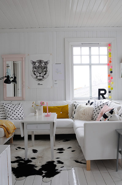 white room with white sofa and animal skin rug